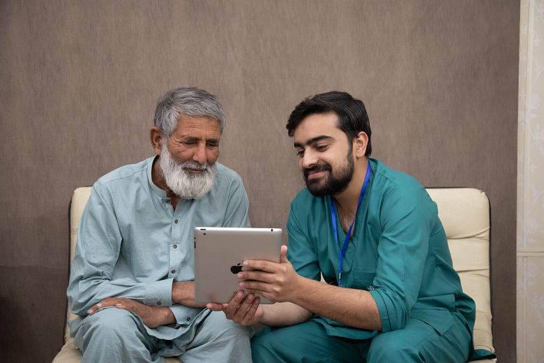 caregiver taking care of elderly patient